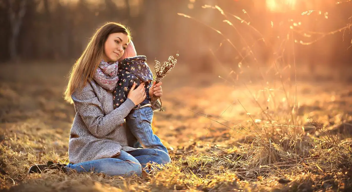 Mother Hugging Child in Nature